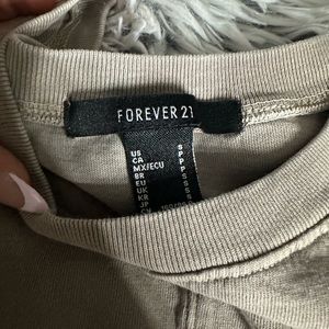 a cropped beige shirt